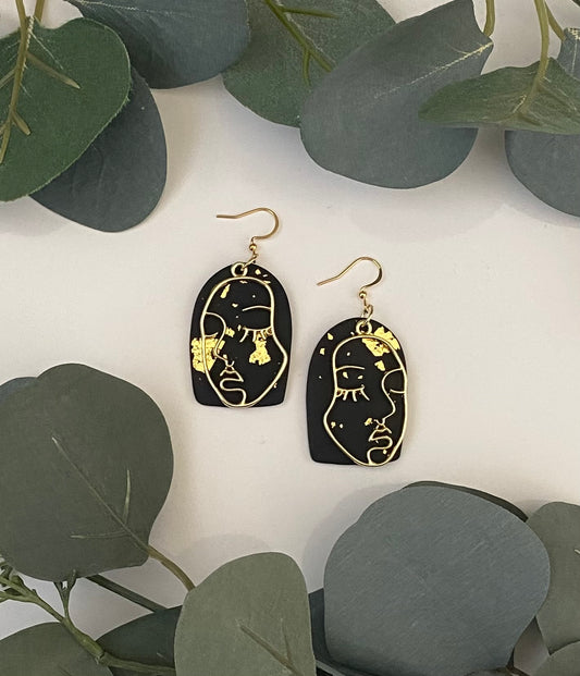 Modern face earrings in black and gold